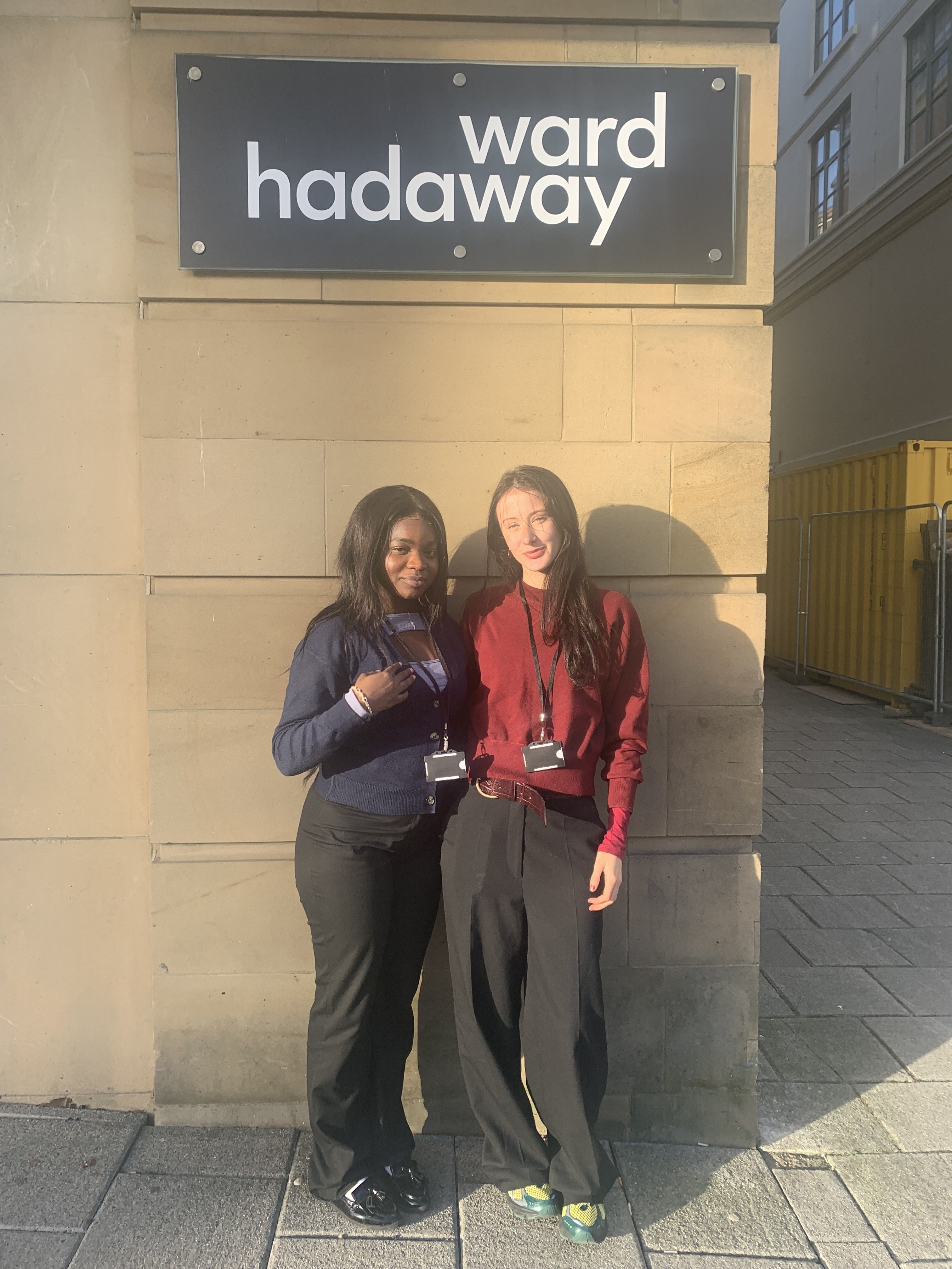 Scholarship winners, Oluwabukolami Adeyemi (left) and Niamh Scott-McCormack (right) standing in front of the ward hadaway sign